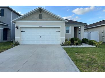 Charming single-Gathering home with a well-manicured lawn and an attached two-car garage at 6783 Grace Hammock Rd, Harmony, FL 34773