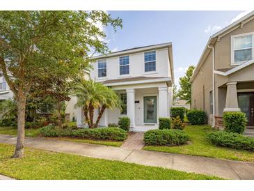 Charming two-story home with a well-manicured lawn and a welcoming front porch at 11843 Fiction Ave, Orlando, FL 32832