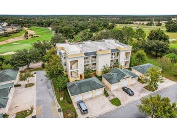 A beautiful condo complex featuring multiple units with garages, and verdant green surroundings at 1501 Northern Harrier Way # 101, Kissimmee, FL 34747
