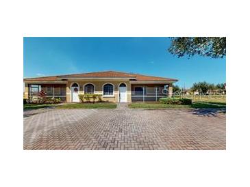 Charming single story villa with brick paved driveway and well-maintained landscaping at 1558 Cumin Dr, Poinciana, FL 34759