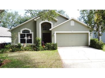 Charming single-Gathering home with a well-manicured lawn and a two-car garage at 2365 Paulette Dr, Haines City, FL 33844