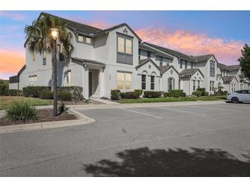 Charming townhome with modern architecture, lush landscaping, and convenient parking at 256 Captiva Dr, Davenport, FL 33896