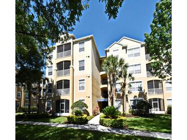 Well-maintained condo complex featuring manicured landscaping and a bright, inviting facade at 2778 Almaton Loop # 403, Kissimmee, FL 34747