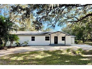 Charming single-story home with a freshly painted white exterior and inviting front yard at 2831 Magnolia Ave, Sanford, FL 32773