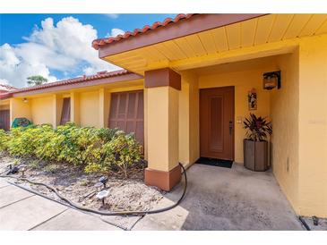 Inviting front entrance with a well-maintained landscape and a charming, covered porch at 5053 Maui Cir # 14, Orlando, FL 32808