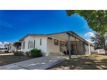 Inviting single-story home with covered porch and driveway on a sunny day at 509 Tivoli Park Dr, Davenport, FL 33897