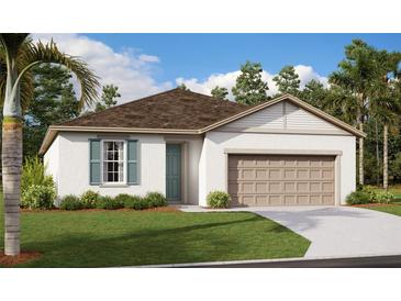 Charming single-story home with a well-manicured lawn and attached two-car garage at 1030 Wisteria Way, Dundee, FL 33838