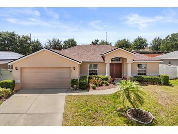 Charming single-story home with a well-manicured lawn and inviting front entrance at 131 Highland Meadows Pl, Davenport, FL 33837