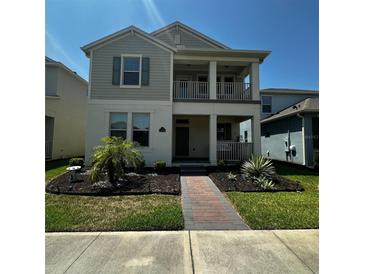 Charming two-story home featuring a welcoming front porch and well-manicured landscaping at 15929 Moonlight Bay St, Winter Garden, FL 34787