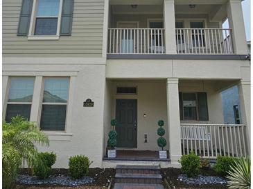 Charming two-story home featuring a covered entry, neat landscaping, and a cozy front porch at 15929 Moonlight Bay St, Winter Garden, FL 34787