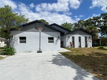 Charming home with a concrete driveway and a basketball hoop at 225 Ronnie Cir, Orlando, FL 32811