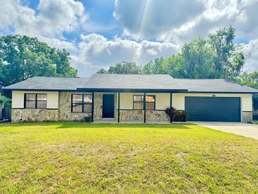 Charming single-story home with stone accents, well-maintained lawn, and a cozy front porch at 4385 Ne 2Nd Ct, Ocala, FL 34479