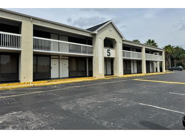 Motel exterior featuring balconies, a large parking area, and easy access to rooms at 5245 W Irlo Bronson Memorial Hwy # 276, Kissimmee, FL 34746
