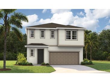 Two-story home with a neutral color scheme, front-facing garage, and well-maintained landscaping at 741 Lake Dell Ave, Dundee, FL 33838