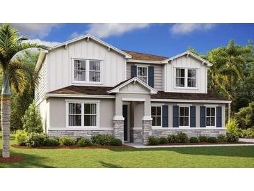 Charming two-story home with stone accents, white siding, blue shutters, and a beautifully landscaped front yard at 1058 Cloud Ridge Ct, Mount Dora, FL 32757