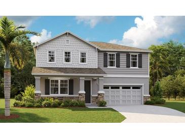 Charming two-story home with stone accents, a well-manicured lawn, and a welcoming covered front porch at 1066 Cloud Ridge Ct, Mount Dora, FL 32757
