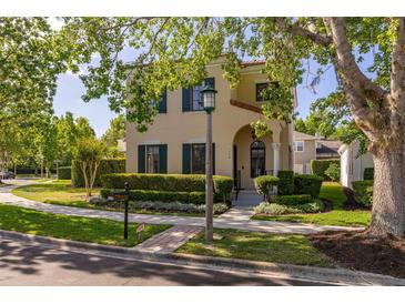 Charming two-story home with a well-manicured lawn and beautiful landscaping at 1116 Oak Pond Dr, Celebration, FL 34747