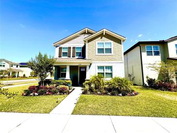 Charming two-story home with well-manicured lawn and lush landscaping at 11688 Founders St, Orlando, FL 32832