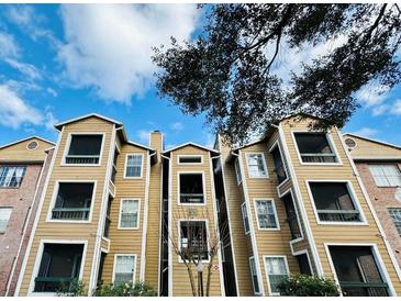 Charming exterior of a condo complex with wood facade and ample windows at 4301 Lizshire Ln # 306, Orlando, FL 32822