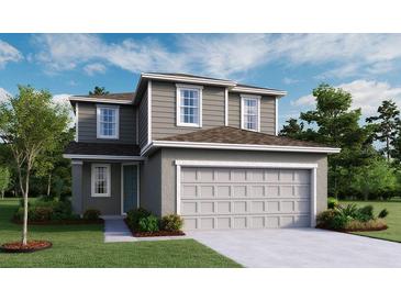 Charming two-story home features a symmetrical facade, neutral color palette, and attached two-car garage at 725 Lake Dell Rd, Dundee, FL 33838