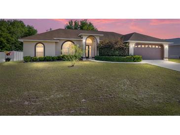 Charming one-story home with meticulously maintained front lawn and landscaping at 7431 Sw 129Th Pl, Ocala, FL 34473