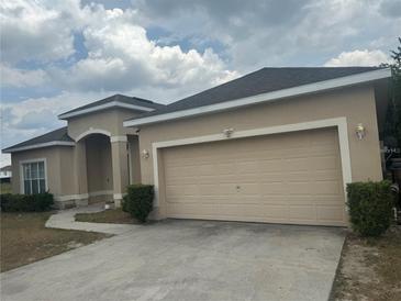 Charming single-story home with a two-car garage and well-maintained front yard at 913 Gascony Ct, Kissimmee, FL 34759