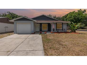 Charming single-story home featuring a well-maintained lawn and a one-car garage at 1622 Crystalview Trl, Lakeland, FL 33801