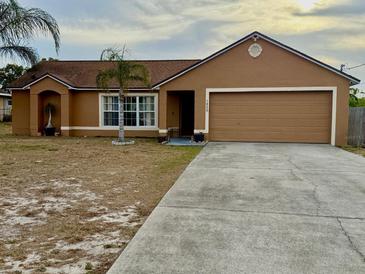 Charming single-story home features a two-car garage and long driveway at 1820 Hallcrest Dr, Deltona, FL 32725