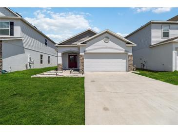 Charming single-story home featuring a well-manicured lawn and a two car garage at 2281 Canyon Breeze Ave, Kissimmee, FL 34746