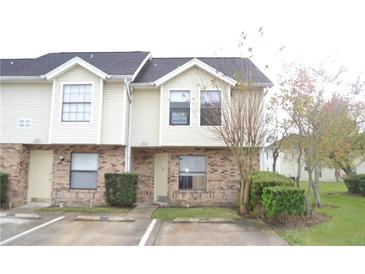 Inviting two-story townhome with neutral siding, brick accents, and well-maintained landscaping at 3214 Rio Grande Trl # 1, Kissimmee, FL 34741