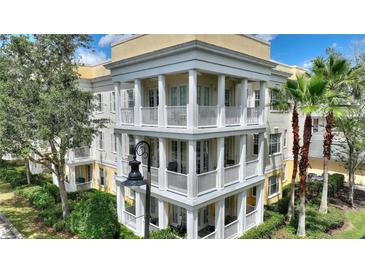 Stunning three-story condo building featuring elegant balconies and classic architectural details at 7509 Mourning Dove Cir # 201, Reunion, FL 34747