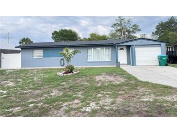 Charming single-story home with a blue exterior, manicured lawn, and attached garage at 31 S Edgemon Ave, Winter Springs, FL 32708
