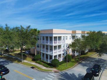 Stunning building with multiple levels, complemented by lush landscaping, and beautiful balconies at 7503 Mourning Dove Cir # 101, Reunion, FL 34747