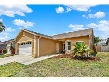 Charming one-story home with a two-car garage, well-maintained lawn, and beautiful landscaping at 1050 Dees Dr, Oviedo, FL 32765