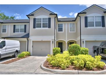 Charming townhome featuring a two-car garage and inviting landscaping at 3151 Sinclair St # 104, Orlando, FL 32835