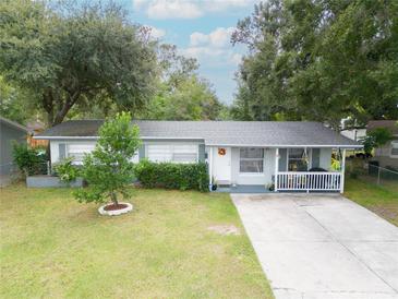 Charming single-story home featuring a well-manicured lawn and inviting front porch at 4760 Danzig Ct, Orlando, FL 32811