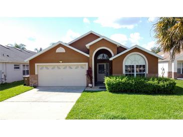 Charming single-Gathering home with attached garage, lush lawn, and well-maintained landscaping at 8019 Indian Creek Blvd, Kissimmee, FL 34747