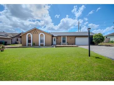 Charming single-story home featuring a well-manicured lawn and classic architectural details at 987 Trumbull St, Deltona, FL 32725