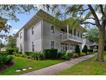 Charming two-story home features a beautiful balcony, landscaped yard, and inviting curb appeal at 1211 Celebration Ave # 102, Celebration, FL 34747