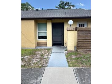 Inviting front entrance of the home with well-kept walkway and visible house number at 108 Creekside Way, Orlando, FL 32824