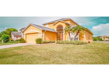 Charming two-story home boasting a well-manicured lawn, lush landscaping, and a two-car garage at 2650 Patrician Cir, Kissimmee, FL 34746