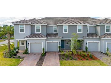 Charming multi-Gathering home features a well-maintained exterior, attached garages, and manicured landscaping at 3575 Landing Net Dr, Kissimmee, FL 34746