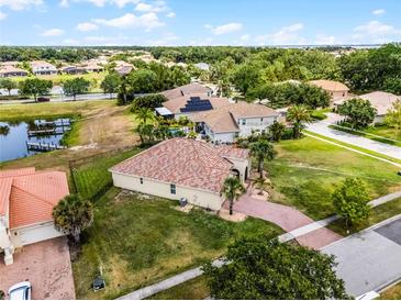 Areal view of a single Gathering home with a brick roof and well-manicured lawn in a desirable neighborhood at 3881 Shoreside Dr, Kissimmee, FL 34746