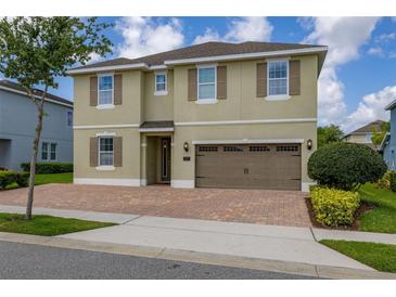 Beautiful two-story home features a paved driveway, attached garage, and manicured landscaping at 420 Burma St, Kissimmee, FL 34747