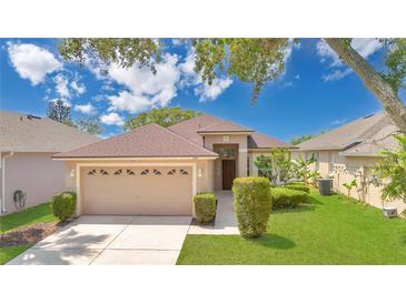 Charming single-story home with manicured lawn, mature trees, and a two-car garage at 5114 Olde Kerry Dr, Orlando, FL 32837