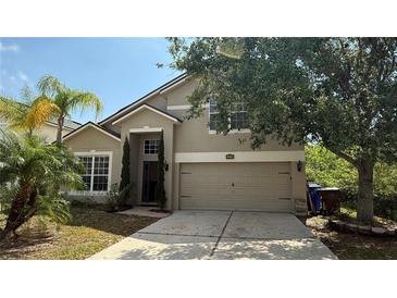 Charming two-story home featuring a well-manicured lawn and a two-car garage at 979 Hacienda Cir, Kissimmee, FL 34741