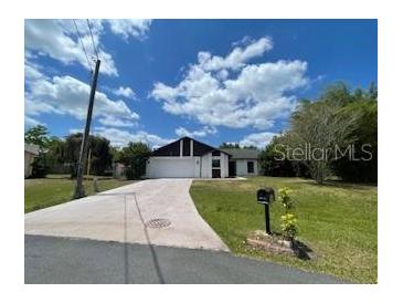 Charming single-story home featuring an attached garage and a well-manicured front yard at 116 Talavera Ln, Kissimmee, FL 34758