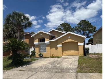 Charming single-story home with well-maintained landscaping and an attached garage at 2711 Emerson Ln, Kissimmee, FL 34743