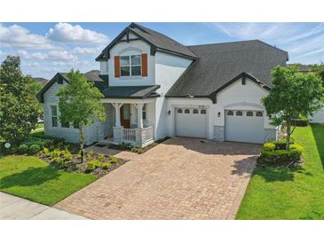 Beautiful two-story home boasting a spacious three-car garage and lovely landscaping at 8378 Randal Park Blvd, Orlando, FL 32832