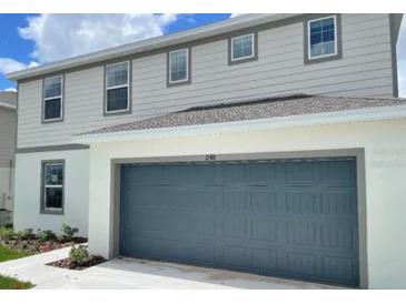Charming two-story home with a two-car garage and well-maintained landscaping at 1148 Sugarwood St, Davenport, FL 33837